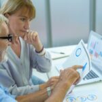 Kaukaski senior Biznesmeni pracujący i burzący mózgi w nowoczesnym biurze