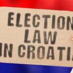 Fraza Prawo wyborcze w Chorwacji na banerze w rękach mężczyzn z zamazaną chorwacką flagą w tle Konstytucja Polityczny Senat Zagrzeb Elektorat Większość