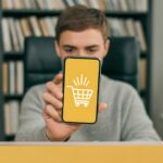 Man Presenting Mobile E-commerce App on Smartphone