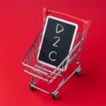 Mini shopping cart holding a chalkboard with D2C text Direct to consumer business model ecommerce